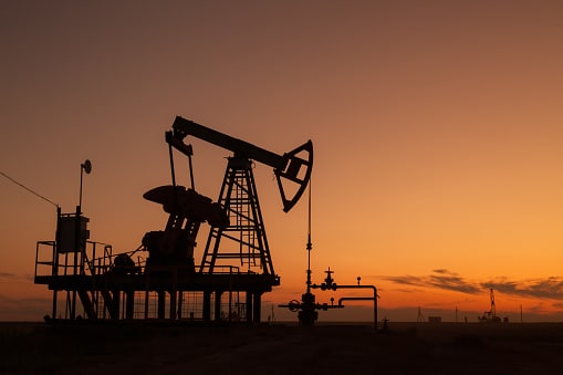 oil pumps at sunset,  industrial oil pumps equipment.