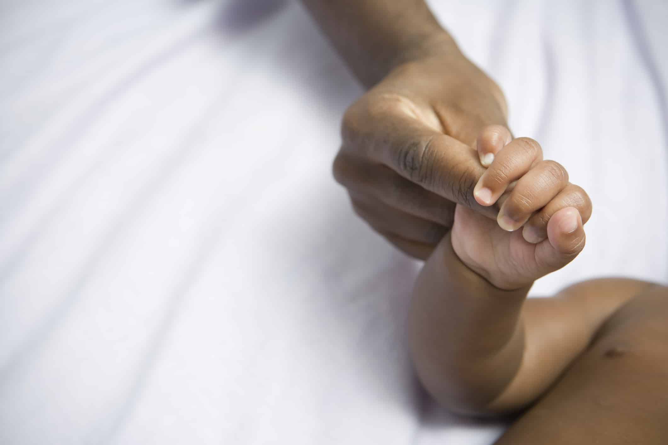 African American Baby and Mom holding hands
