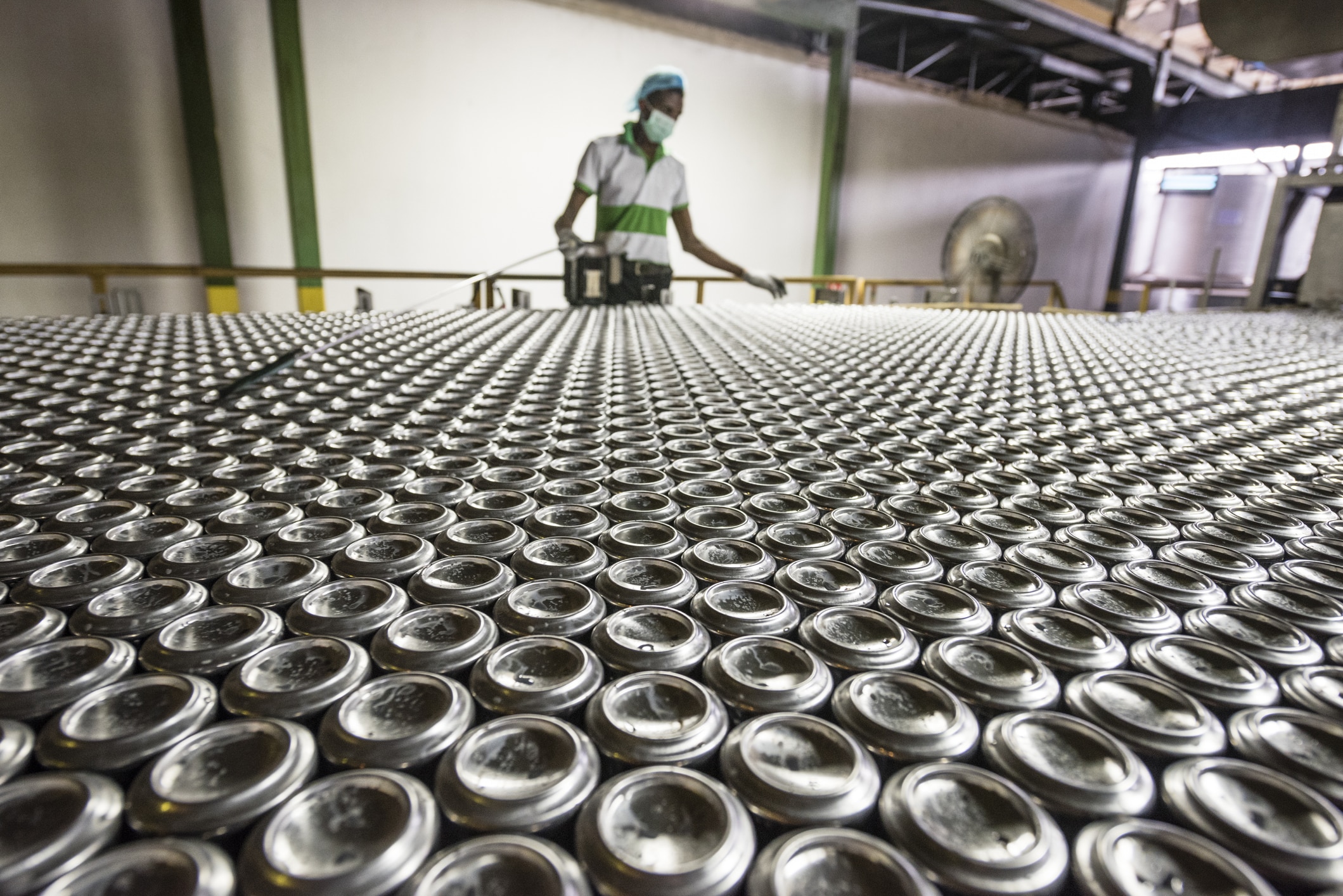 Man working in aluminium can processing plant