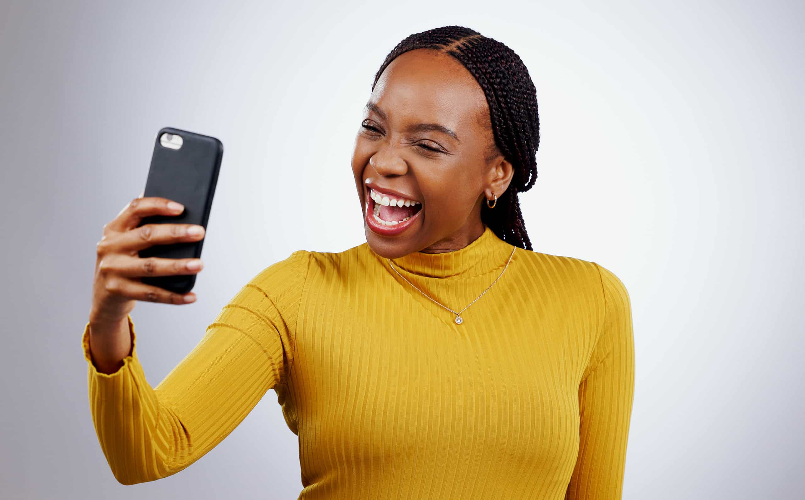 Happy woman, selfie or video call for social media, influencer content creation and online blog on a white background. African person with smile and excited for profile picture photography in studio