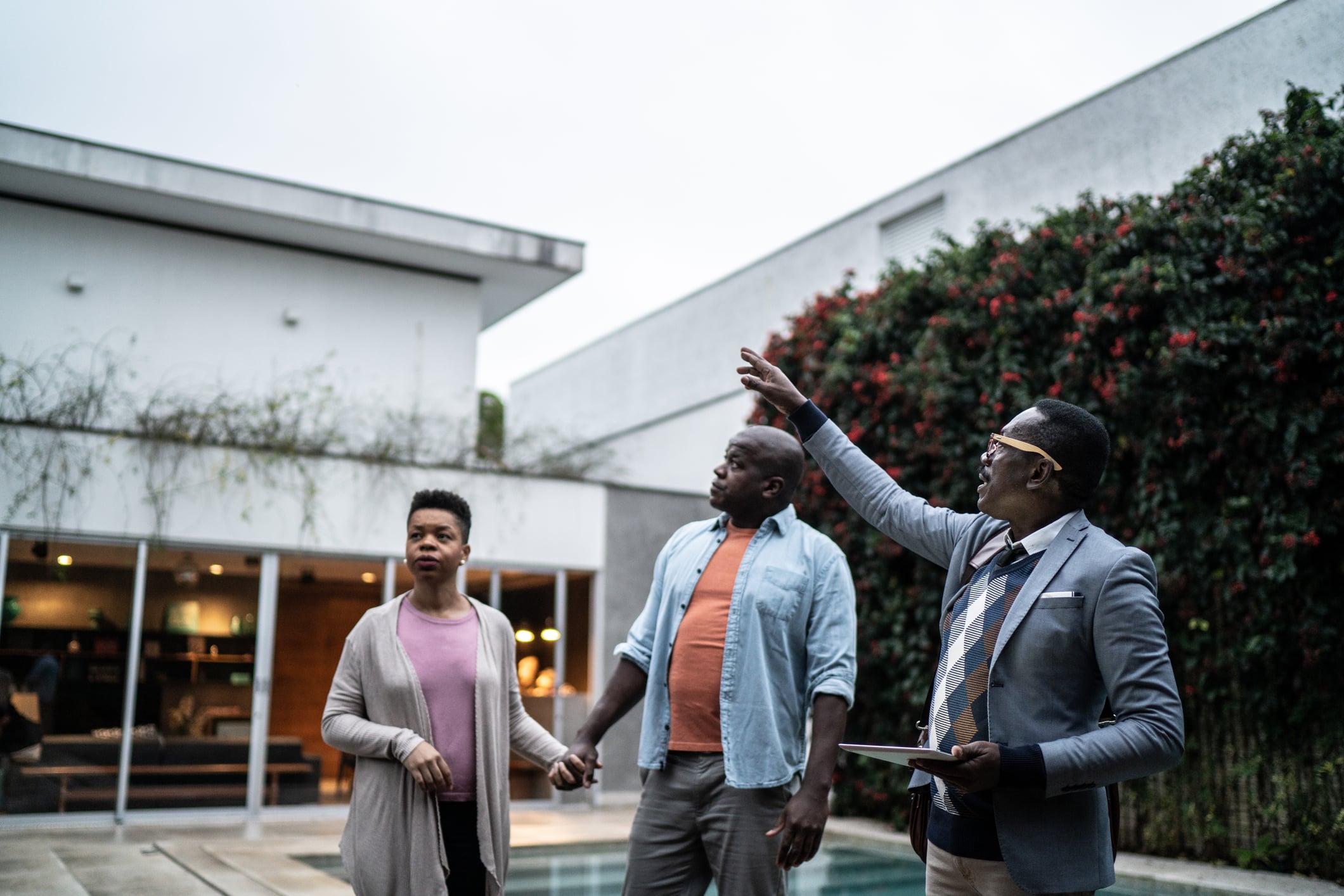 Real estate agent showing new house to customers