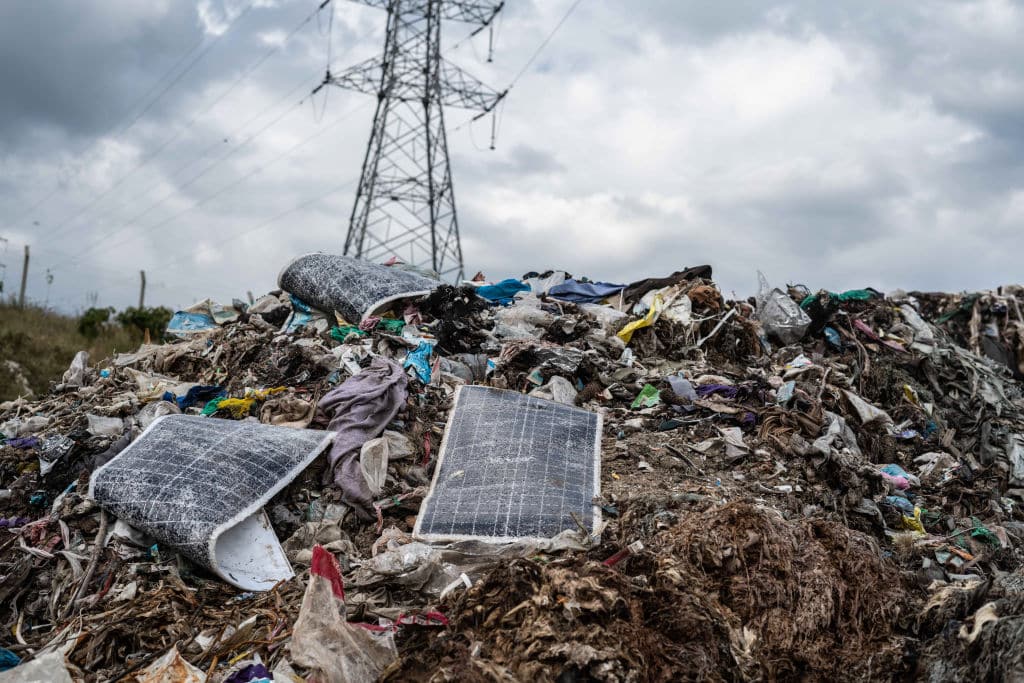 A view of discarded solar panel components below a power