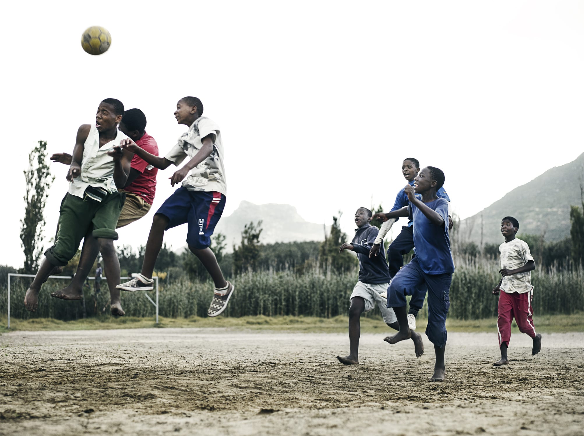 South Africa, Cape Town, Hout Bay, boys (14-17) and men playing soccer