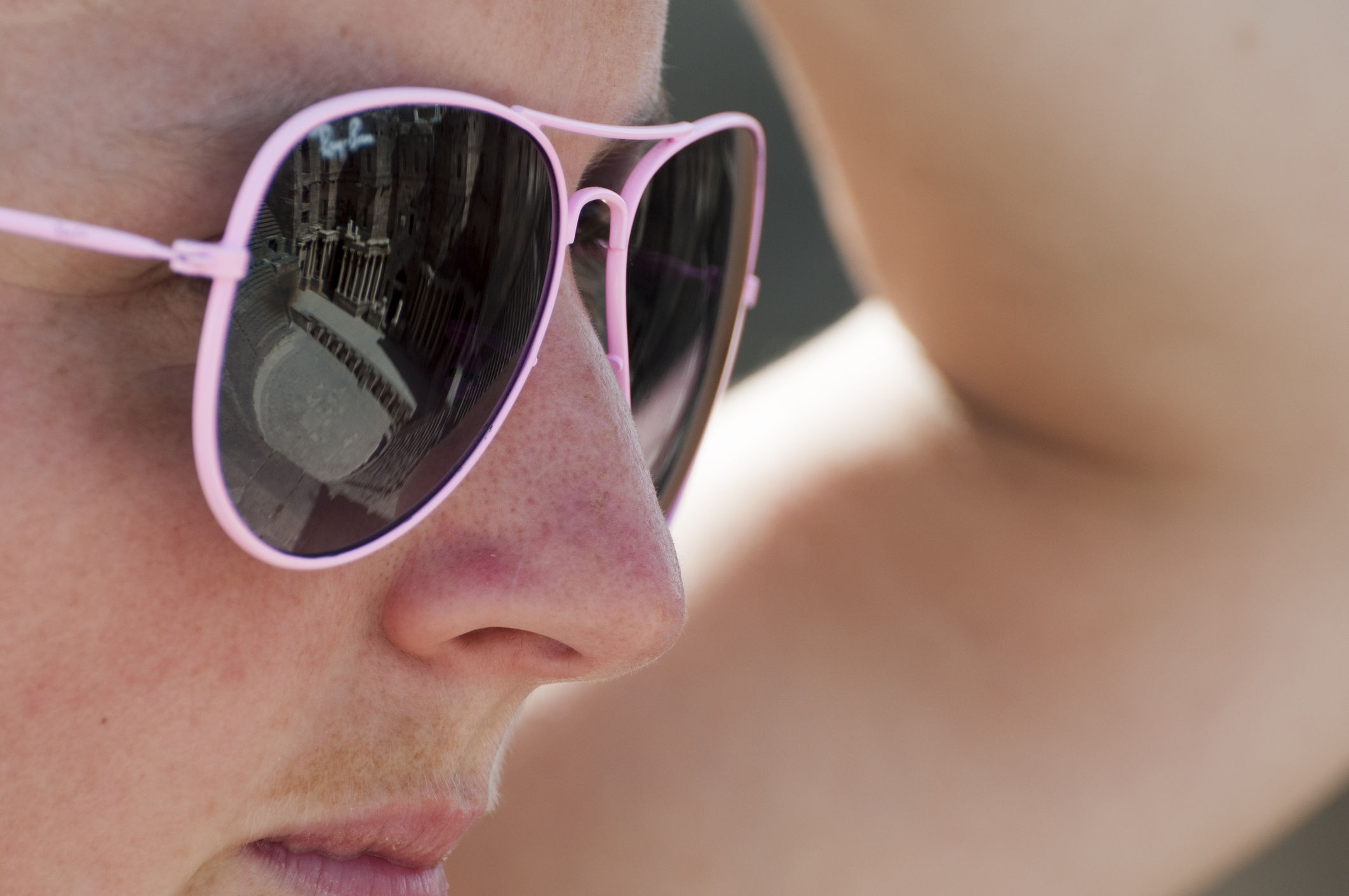 Tourist sunglasses reflecting Roman theater in Bosra, Syria