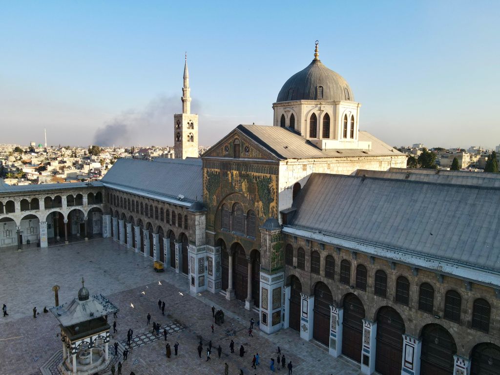 Crowds gather at Umayyad Mosque following the collapse of 61-year of Baath Party rule in Syria