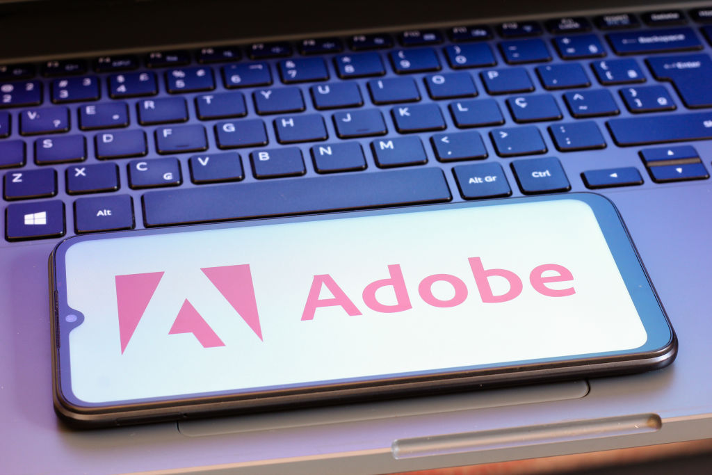 In this photo illustration, the Adobe, Inc. logo is seen