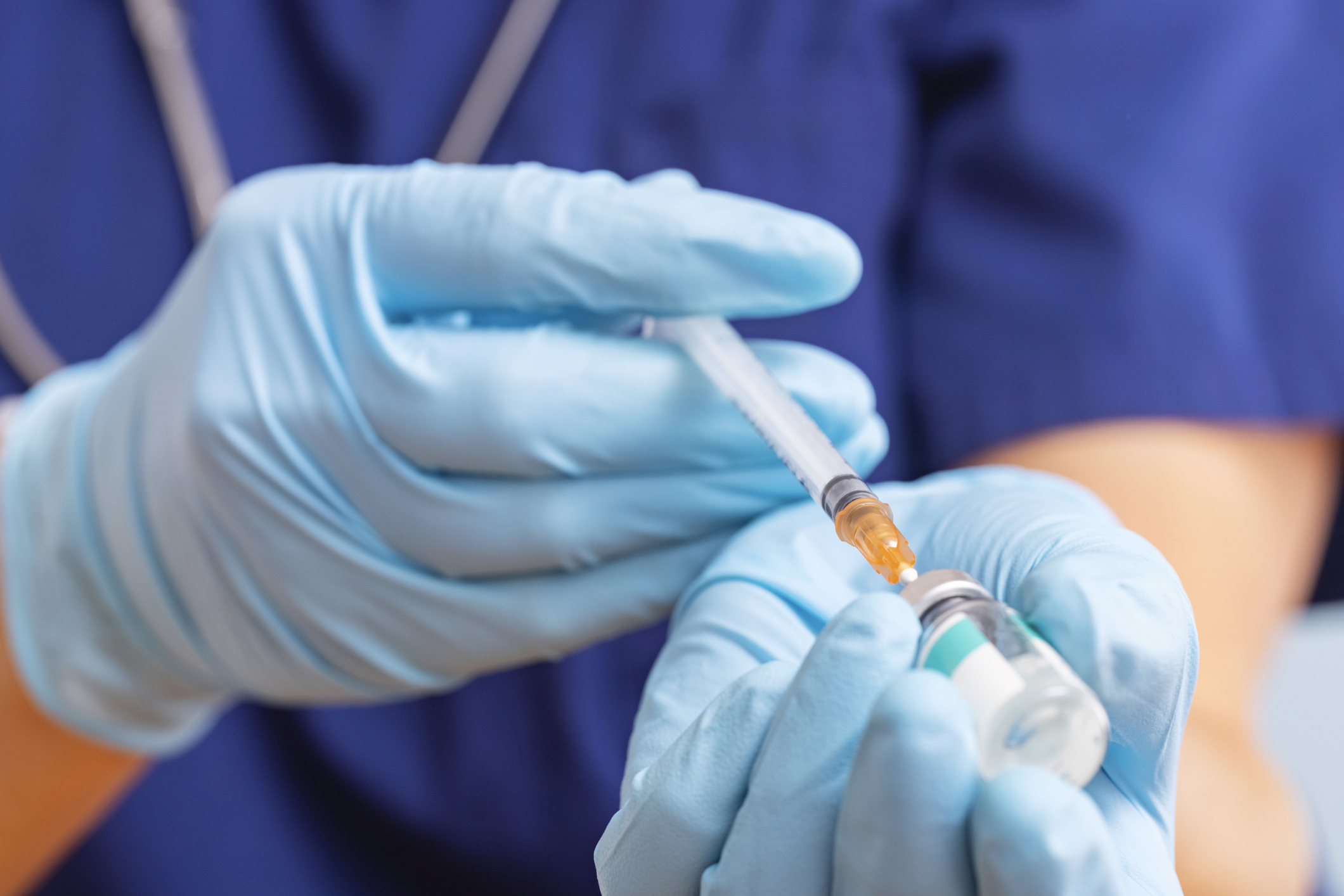 Doctor fills syringe with medicine from vial. Vaccination and immunization