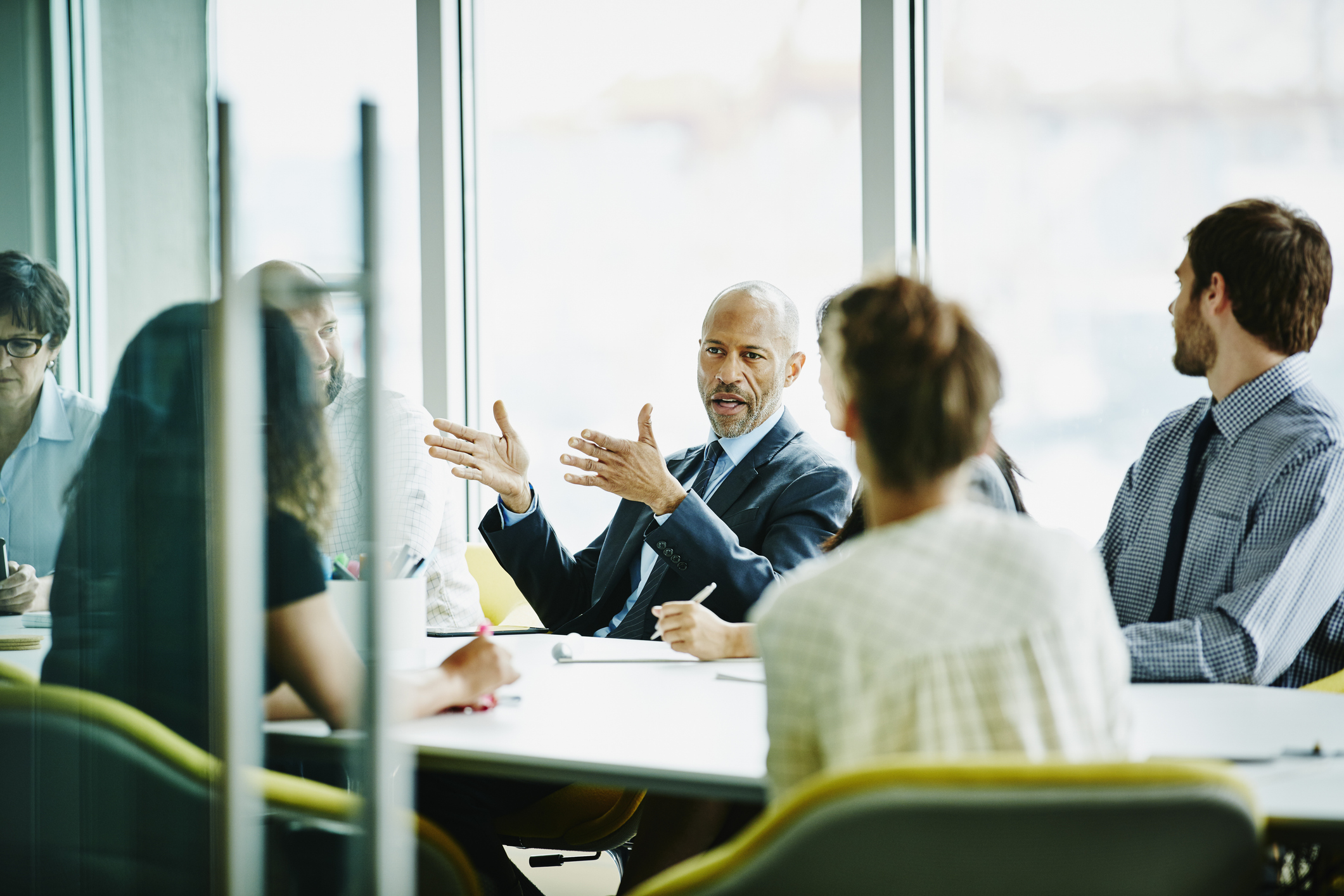 Mature businessman leading meeting in office