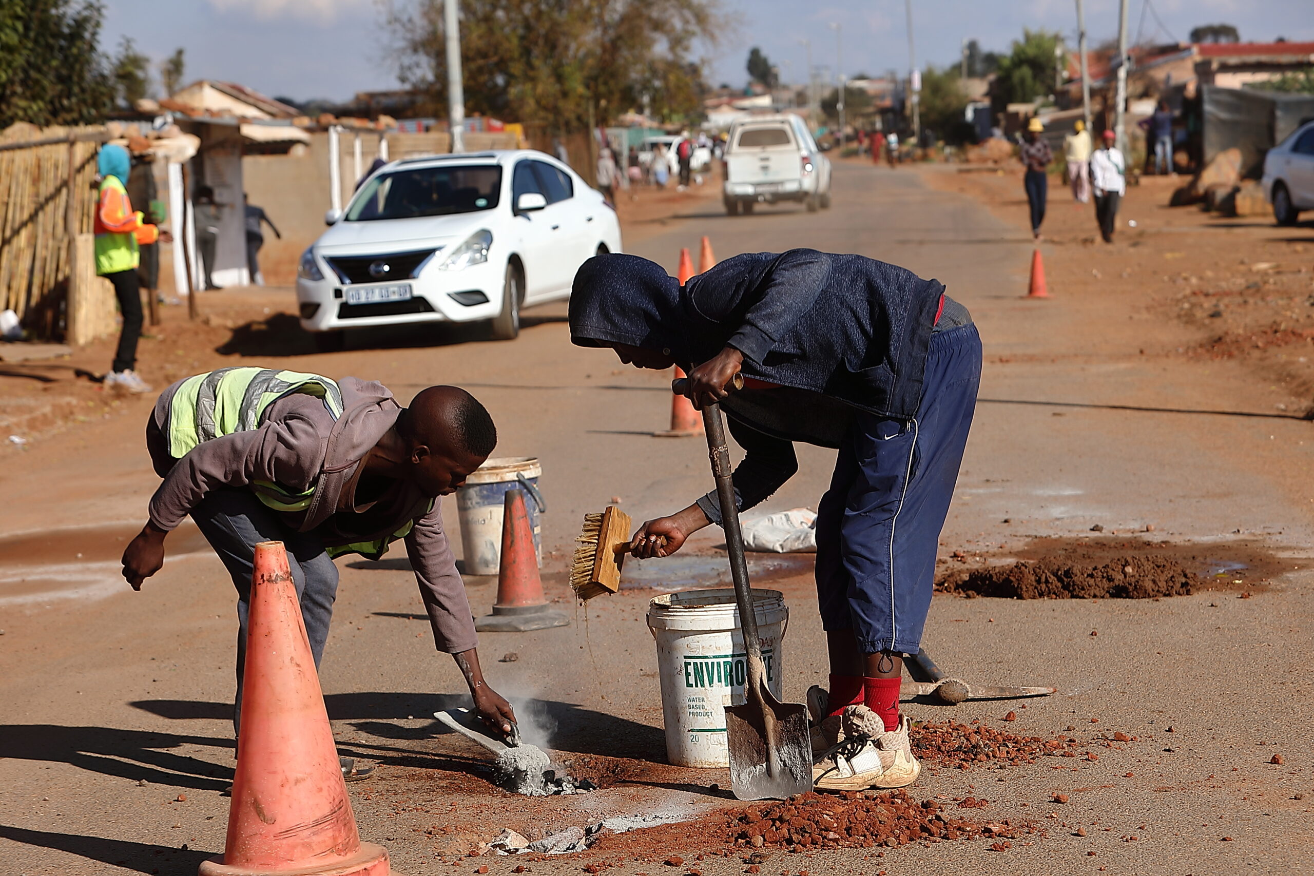 Unemployed township youths fix potholes to earn a living