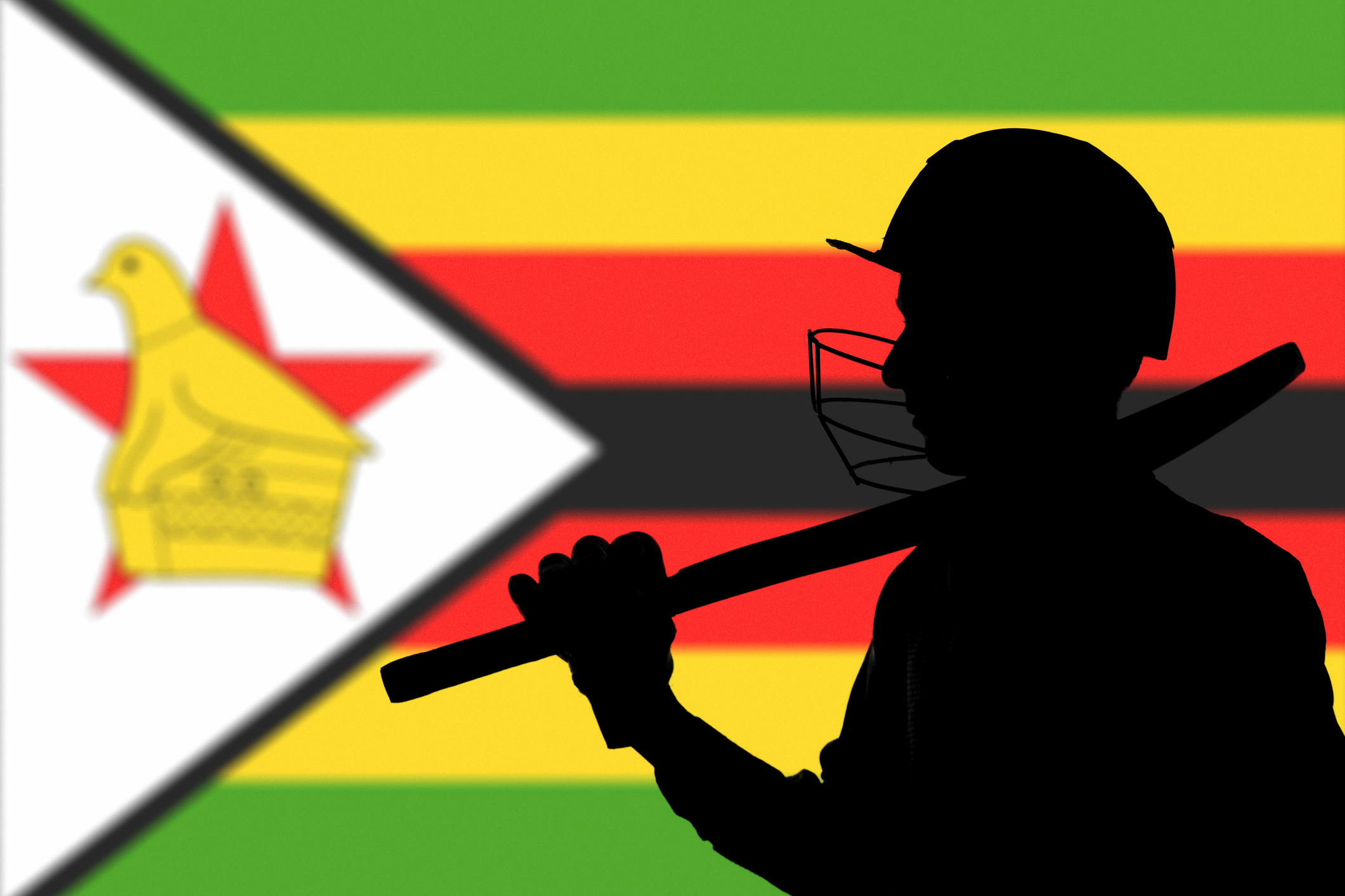 Cricketer silhouette on Zimbabwe blurred flag background